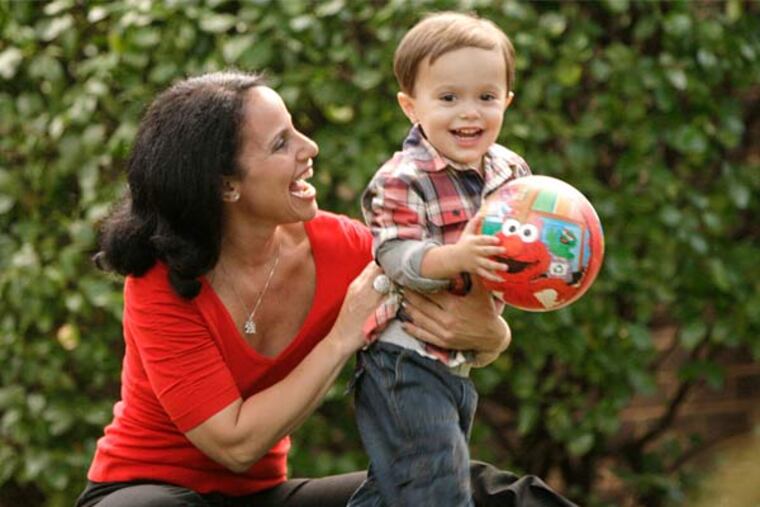Shari Botwin and her 2-year-old son, Andrew, play outside their home in Narberth. (Elizabeth Robertson/Staff Photographer)