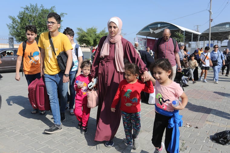 Palestinians cross to the Egyptian side of the border crossing with the Gaza Strip in Rafah on Wednesday.