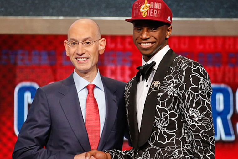 NBA Commissioner Adam Silver, left, congratulates Andrew Wiggins of Kansas who was selected by the Cleveland Cavaliers as the number one pick in the 2014 NBA draft, Thursday, June 26, 2014, in New York. (Jason DeCrow/AP)