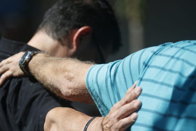 Attendees pray together at a vigil for the victims of the shooting at Marjory Stoneman Douglas High School at the Parkland Baptist Church, Thursday, Feb. 15, 2018, in Parkland, Fla. Nikolas Cruz, a former student, was charged with 17 counts of premeditated murder Thursday morning. (AP Photo/Wilfredo Lee)