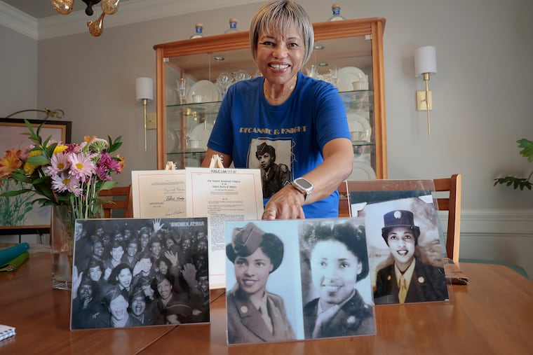 Karen Jordan displays Army photos of her mother, Pfc. Annie B. Knight, taken between November 1943 and March 1946, when she served in the 6888th Central Postal Directory Battalion.