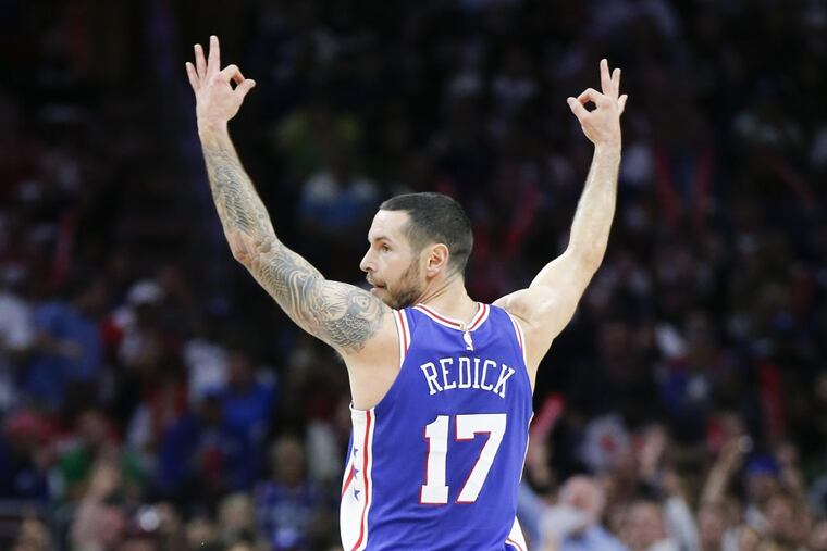 Sixers guard JJ Redick raises his fingers after making a three point basketball against the Boston Celtics on Friday.