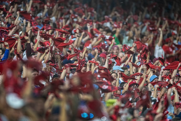 Phillies fans wave their towels in the first inning of Game 2 of the team's wild-card series against the Miami Marlins.