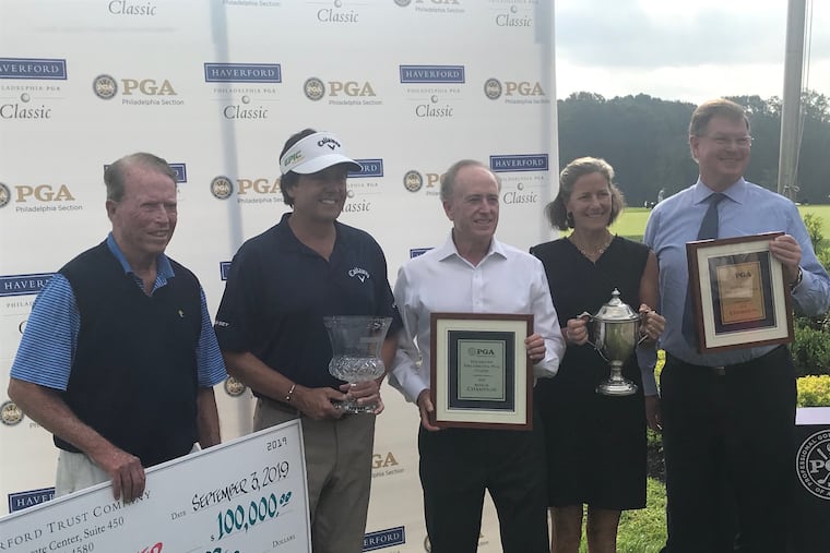 George Forster, second from left, holding the Haverford Philadelphia PGA Championship trophy.