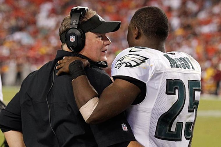 Eagles head coach Chip Kelly talks with running back LeSean McCoy. (Alex Brandon/AP)