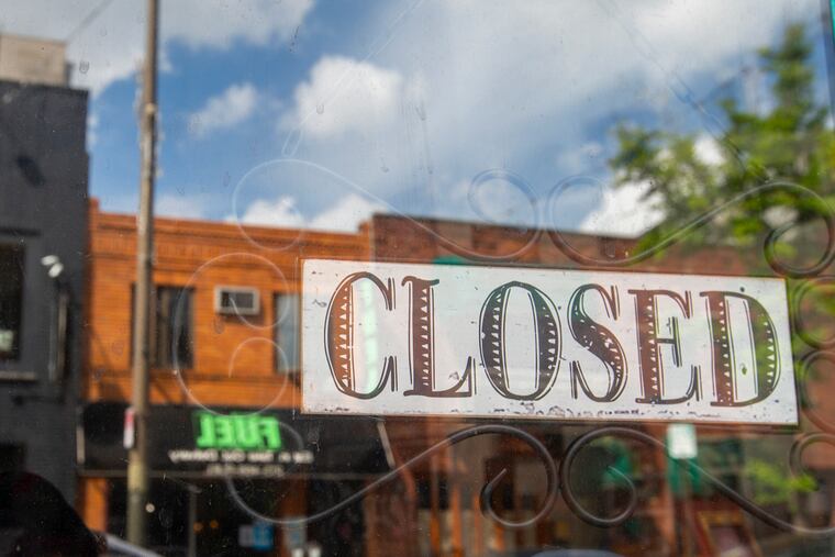 A closed sign on a business on East Passyunk Avenue in May.