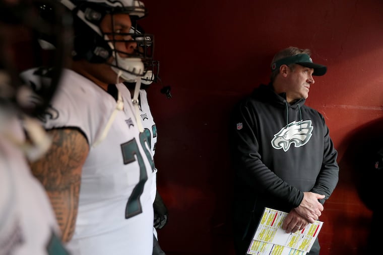 Eagles head coach Doug Pederson, right, looks out at FedEx Field before the Eagles clinched their playoff spot.