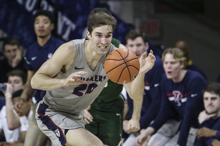 Penn's Matt MacDonald drives past Dartmouth's James Foye during the 1st half at The Palestra, Friday, February 23, 2017.