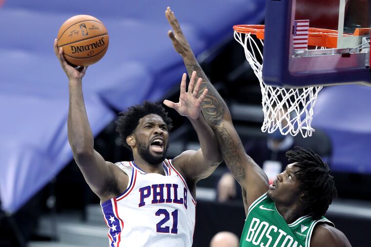 Joel Embiid of the Sixers scores against Robert Williams of the Celtics during the first half.