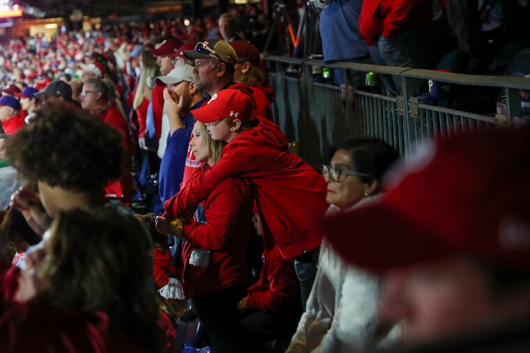 Philadelphia Phillies fans watch as Philadelphia Phillies designated hitter Bryce Harper strikes out at the bottom of the seventh inning.