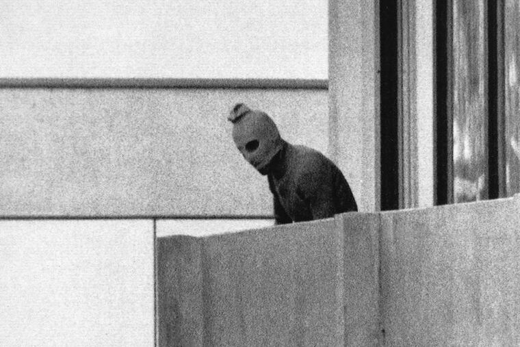 One of the most iconic images of the 1972 Munich Olympics: A member of the Black September terror group on the balcony of the Israeli team's quarters.
FILE PHOTOS