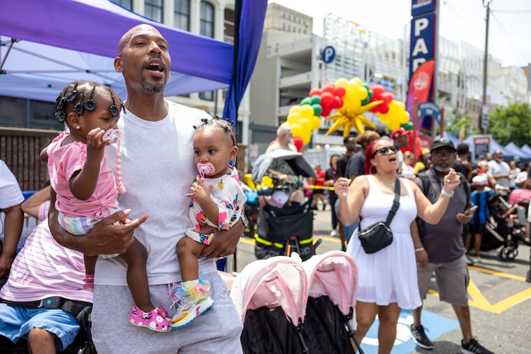 Bernard Clark, of Wynnefield, Pa., is with his twin granddaughters Rylan and Mahyraa Clark, 1, at the Juneteenth Block Party at the African American Museum in Philadelphia, Pa., on Friday, June 19, 2026.