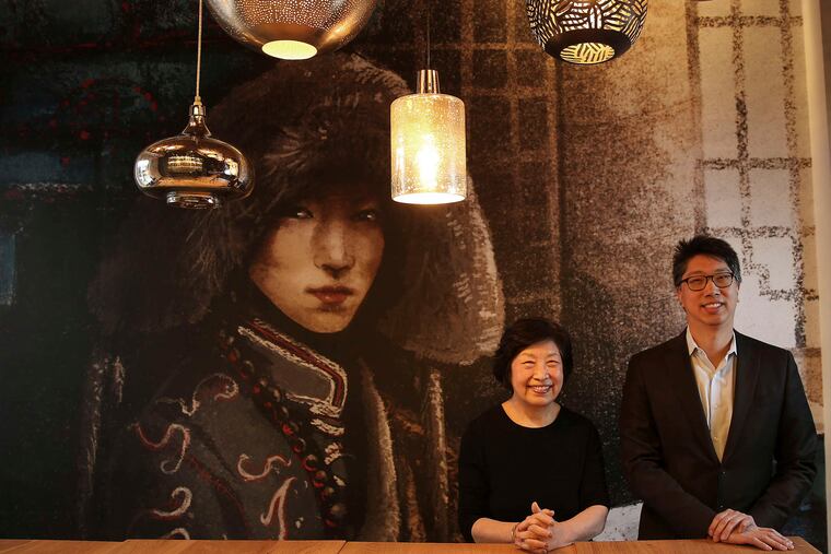 Chef Susanna Foo and son Gabriel before a mural of a woman in Mongolian attire at SuGa, shortly before the opening in 2016.