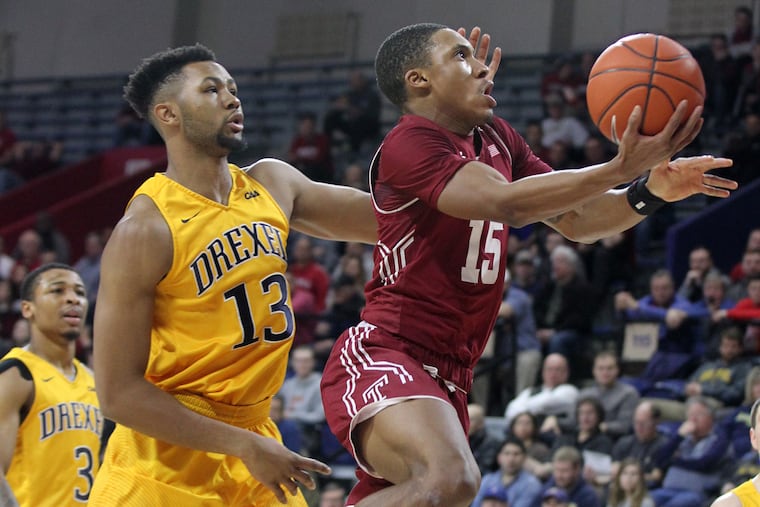 Nate Pierre-Louis, right, goes past Tim Perry of Drexel for a basket in the 1st half on Dec. 22, 2018 at the Palestra. CHARLES FOX / Staff Photographer