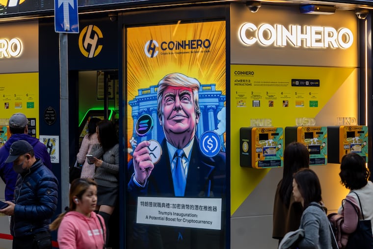 A cartoon image of Donald Trump with cryptocurrency tokens, depicted in front of the White House to mark his inauguration, displayed at a Coinhero store in Hong Kong on Jan. 20.