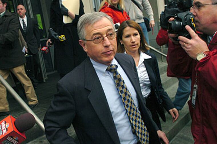 In this Feb. 12, 2009, file photo, Mark Ciavarella, center, leaves the federal courthouse in Scranton, Pa. Two former Pennsylvania judges, Michael Conahan and Ciavarella, were indicted on federal racketeering charges for improperly placeing juveniles in privately owned detention centers. (AP Photo / David Kidwell)