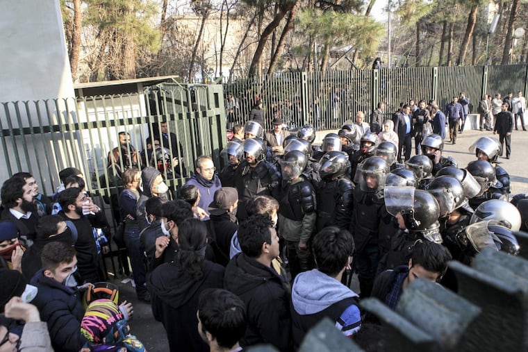 In this photo taken by an individual not employed by the Associated Press and obtained by the AP outside Iran, anti-riot Iranian police prevent university students to join other protesters over Iran weak economy, in Tehran, Iran, Saturday, Dec. 30, 2017. A wave of spontaneous protests over Iran's weak economy swept into Tehran on Saturday, with college students and others chanting against the government just hours after hard-liners held their own rally in support of the Islamic Republic's clerical establishment. (AP Photo)