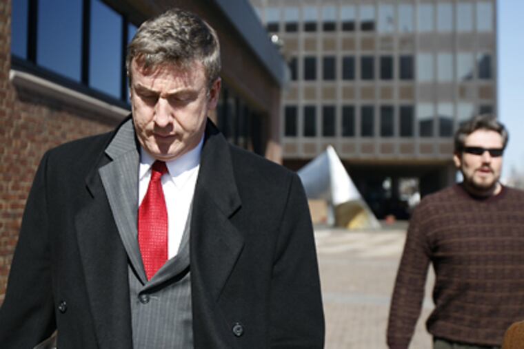 Chris Wright (left) leaves federal court in February after being found guilty of corruption charges. (David Maialetti / Staff Photographer)