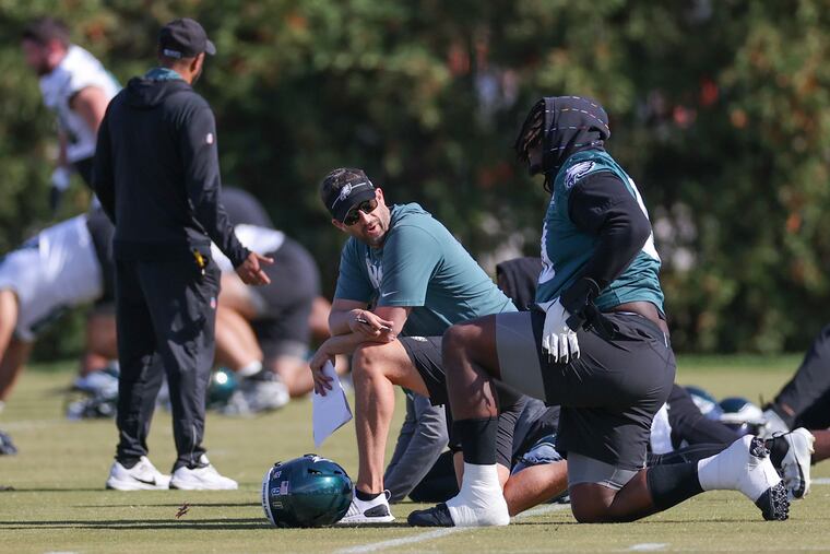Philadelphia Eagles head coach Nick Sirianni checks in with Jordan Davis before practice at the NovaCare Complex in Philadelphia on Thursday, Oct. 26, 2023. The Eagles will face the Washington Commanders on Sunday.