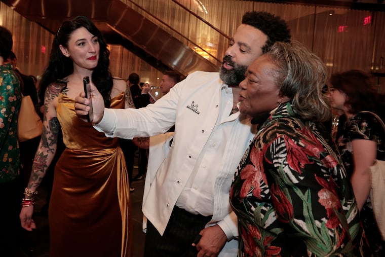 Hanna Williams looks on as husband Chad and Lynette Brown-Sow do a Facetime after the Michelin Awards at the Kimmel Center in Philadelphia on Nov. 18, 2025.