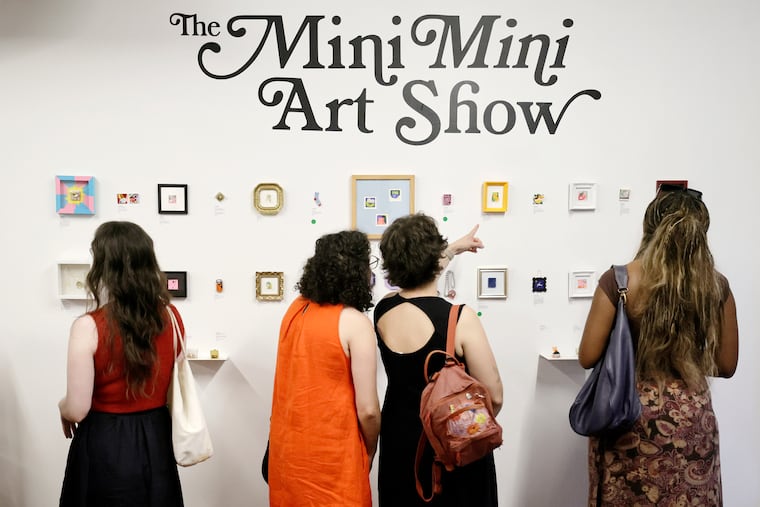 People explore the opening/public reception of the exhibition “The Mini Mini Art Show” at the store “At My House” on 4th Street in Philadelphia on Friday, July 24, 2026. Every artwork in the exhibition measures 1.5” by 1.5” or smaller (size of a postage stamp).