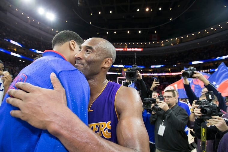 Kobe Bryant hugs members of the Sixers following his final game in Philadelphia on Dec. 1, 2015. (CHARLES FOX / Staff Photographer)