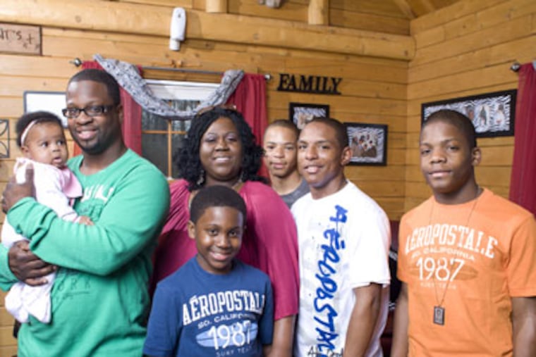 The brothers (from left) Christopher, 10; Terrell, 16; Michael, 15; and Tre Shawn, 20; are thriving with their new parents, James and Amber Parrish. (Ed Hille / Staff Photographer)