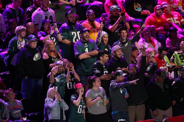 Eagles fans chant Jason Kelce’s name during the Super Bowl LVII Opening Night event at the Footprint Center on Monday in Phoenix.