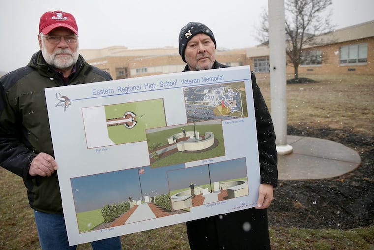 Jack Gangluff, left, and John Masso stand outside Eastern Regional High School in Voorhees at the future site of a memorial to their teammate Joseph Lauer, a US Marine who was killed in Vietnam in 1968.