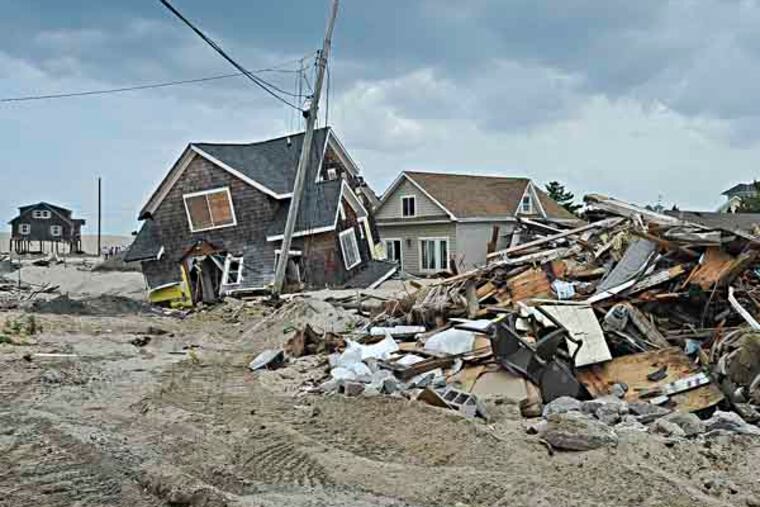 Homes destroyed by Hurricane Sandy in Camp Osborn NJ wait to be demolished. Township and DEP officials were there to talk about the second phase of rebuilding and to take questions. ( RON TARVER / Staff Photographer )