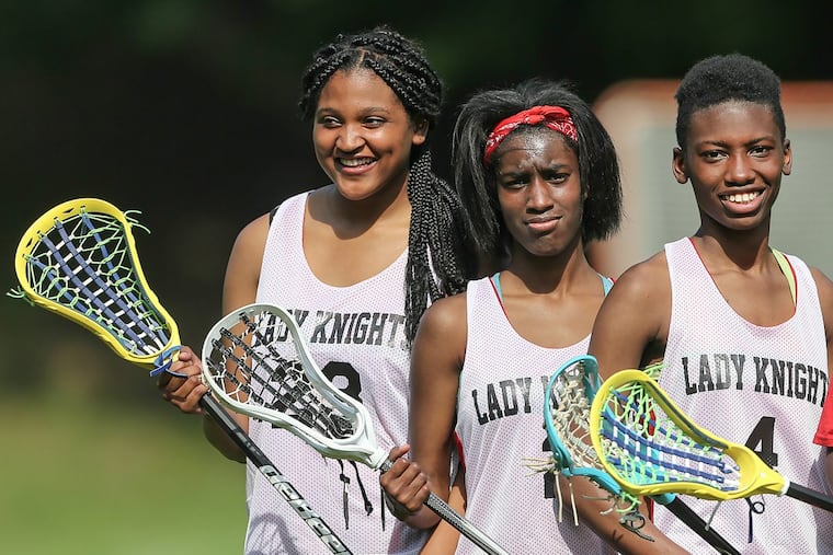 Strawberry Mansion’s lacrosse team — with players (from left) Kava Thompson, Nadirah Gateward and Nadirah McRae — is part of a bias class-action suit.
