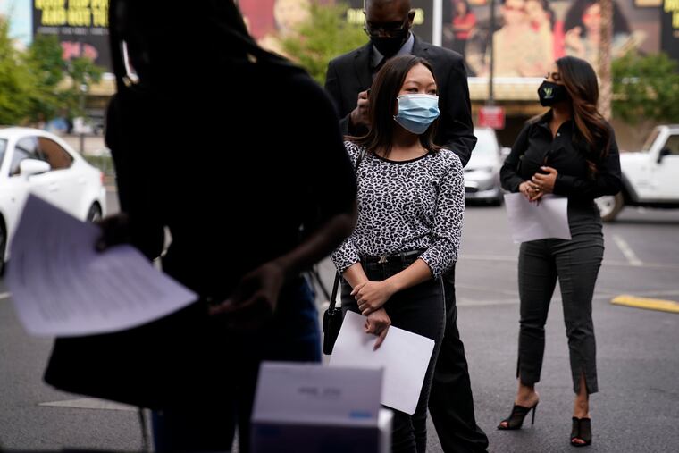People wait in line, resumés in hand, while waiting to apply for jobs during an outdoor hiring event for the Circa resort and casino on Tuesday in Las Vegas.