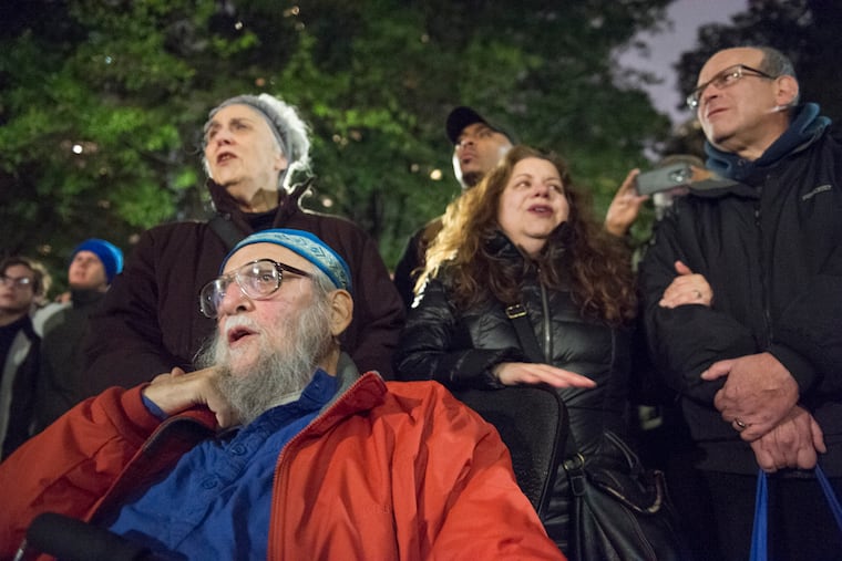 Rabbi Arthur Waskow and Barbara Breitman sing songs in Philadelphia's Rittenhouse Square during a vigil for the victims of the shooting at The Tree of Life Congregation in Pittsburgh.