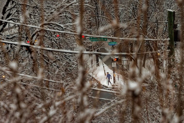 Early morning runner along Kelly Drive and Water Works Drive after an overnight snow fall, Philadelphia, Wednesday morning, Feb. 12, 2025.