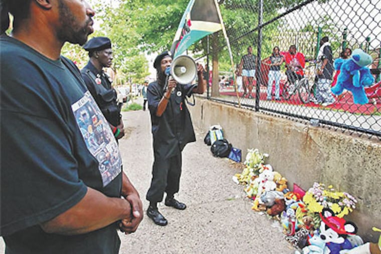 King Samir Shabazz (with bullhorn) and the New Black Panthers protest the slaying of a black 14-year-old by a white 18-year-old at 9th and Federal streets in July 2007. The group called the killing a white-supremacist murder. (Steven M. Falk / Staff Photographer)