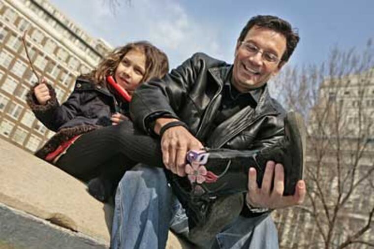 John Bolaris with his daughter, Reina Sofia, 5. "Having a kid has slowed him down, in a good way," said Matt Cord, the WMMR radio personality and 76ers announcer. (Elizabeth Robertson / Staff Photographer)