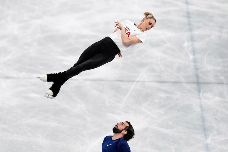 Figure skating USA athletes Ashley Cain-Gribble and Thimothy Leduc, bottom, train at Capital Indoor Stadium at the 2022 Winter Olympics Wednesday in Beijing.