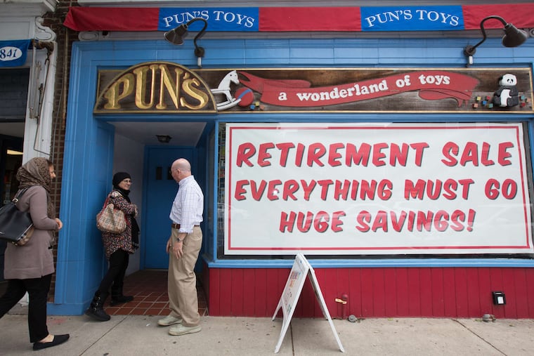 Joe Berardoni, owner of Pun's, greets customers outside the toy shop, soon to be a dress store.