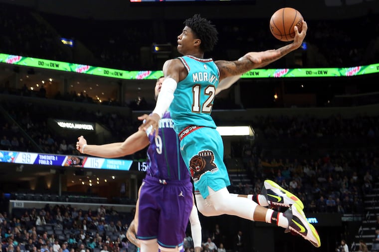 Memphis Grizzlies guard Ja Morant (12) goes up to shoots while defended by Charlotte Hornets center Willie Hernangomez (9) in the second half of an NBA basketball game on Dec. 29.