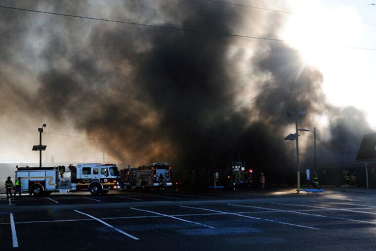 Firefighters respond to a fire at the Columbus Farmers Market on Tuesday, Nov. 18, 2014, in Springfield, NJ. (AP Photo/The Intelligencer, Carl Kosola)