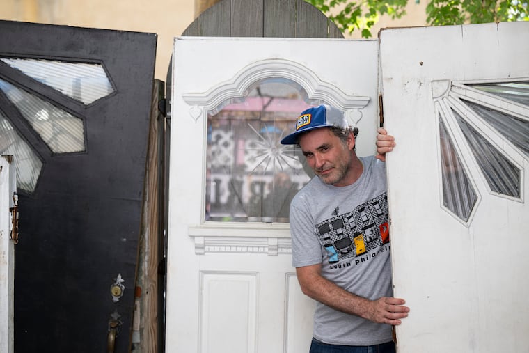 Tony Trov, cofounder of the T-shirt shop and lifestyle brand South Fellini, shows off some of his collection of Tofani doors. The Atwater Kent Collection plans on adding one of Trov's doors to its permanent collection.