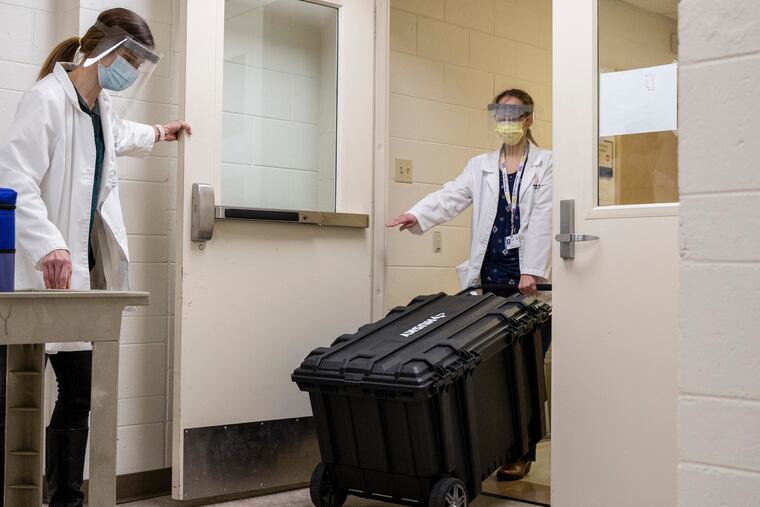 Sarah Tarkington, left, and Laura Caplis, transport the vaccine.
