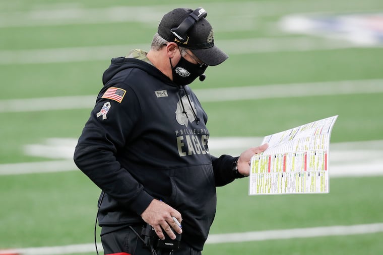 Eagles head coach Doug Pederson looks down at his play chart during the third quarter against the New York Giants on Sunday.