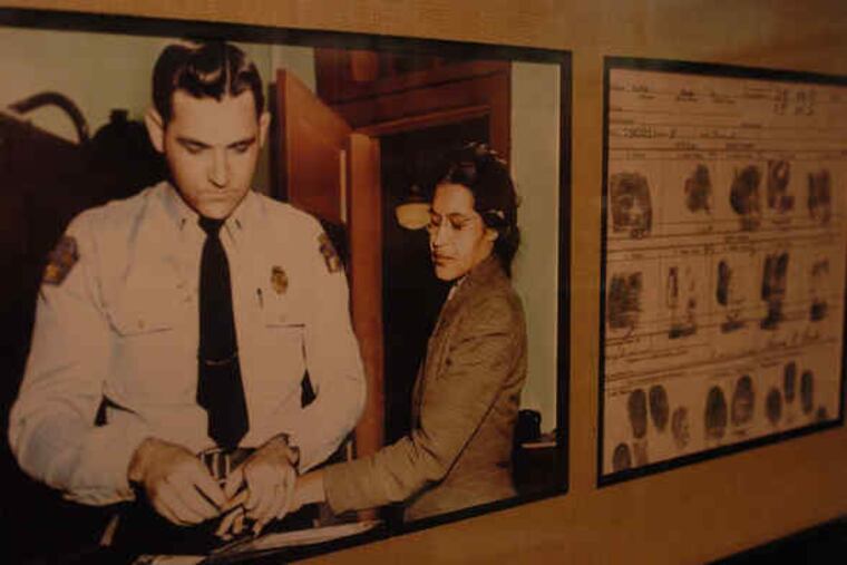 Photograph shows Rosa Parks (right) being fingerprinted in 1955 after her arrest for refusing to give up her seat to a white man on a Montgomery, Ala., bus.