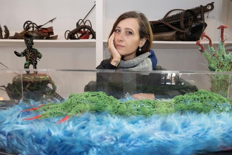 Philadelphia artist Caitlin McCormack poses with their sculpture at their studio in Philadelphia on Friday, Oct. 17, 2025.