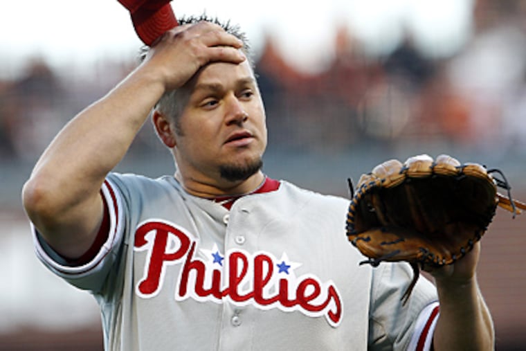 Joe Blanton reacts after throwing a wild pitch in the first inning of Game 4 of the NLCS. (Yong Kim / Staff Photographer)