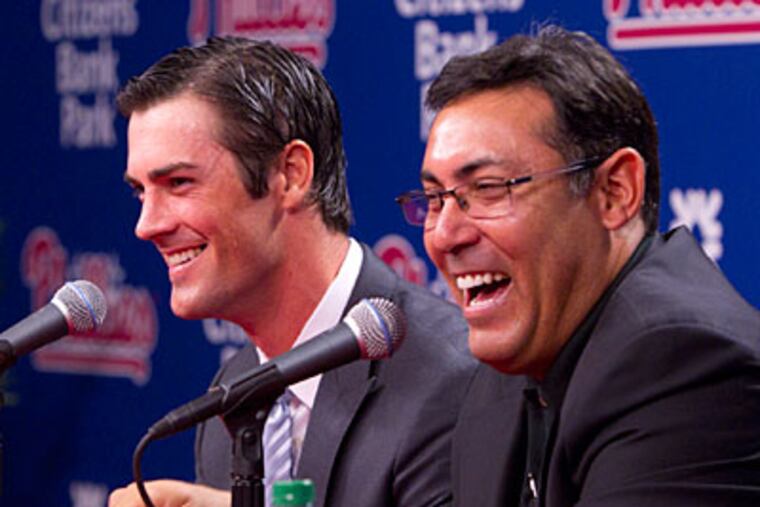 Phillies general manager Ruben Amaro Jr. and pitcher Cole Hamels discuss Hamels' contract extension. (Ed Hille/Staff Photographer)