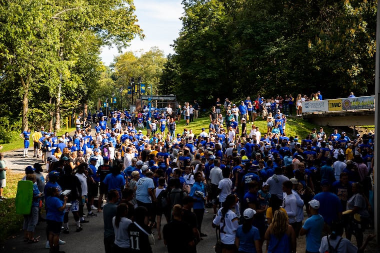 Families and friends cheer as Widener’s players walk out from the locker room after winning their first home game against Hampden-Sydney Tiger’s at Leslie Quick Stadium in Chester, Pa., on Saturday, Sept., 11, 2021.