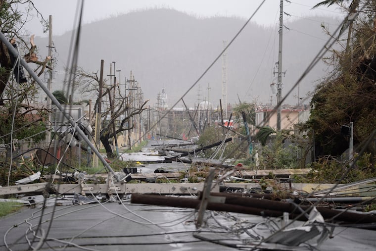 Electricity poles and lines lay toppled on the road after Hurricane Maria hit Puerto Rico in 2017. As Maria, Hurricane Lee underwent a rapid intensification. Only five other storms in the satellite era have gained so much strength so quickly, a hurricane expert says.