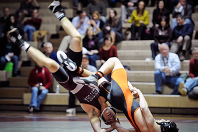 Conestoga's Nick Johnson (left) is flipped by Marple Newtown's Tom Antista in the 145-pound bout, which Antista won by pin. The Tigers had nine wins by pin overall. (Ron Tarver / Staff Photographer)